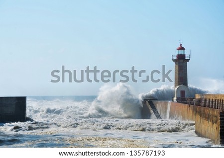 Strong waves hitting the breakwater and the lighthouse
