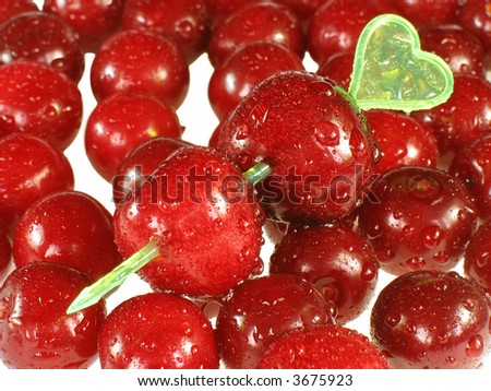 Two red cherries on  arrow on  background of red cherries