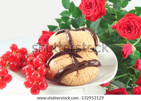 Cookies with chocolate and red currant, still life with roses