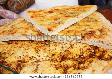 Italian focaccia bread with herbs, olive oil and hot pepper, showcase farm shop