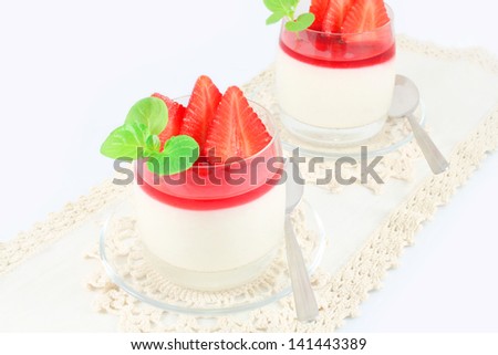 Creamy, vanilla, rice pudding with strawberries, rose water and strawberry syrup