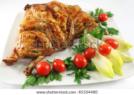 Dish with grilled chicken, tomatoes and endive