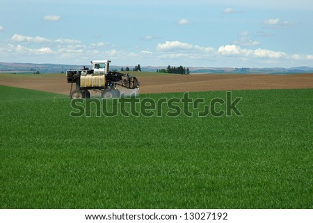 Farm equipment spraying crops