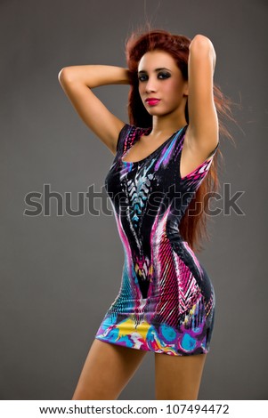 Portrait of a stunning young woman posing in sexy tight print dress