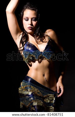 Belly dancer in blue and gold. Dramatic Lighting.