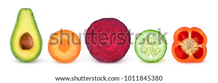 Isolated vegetable slices. Fresh vegetables cut in half (avocado, carrot, beetroot, cucumber, bell pepper) in a row isolated on white background with clipping path