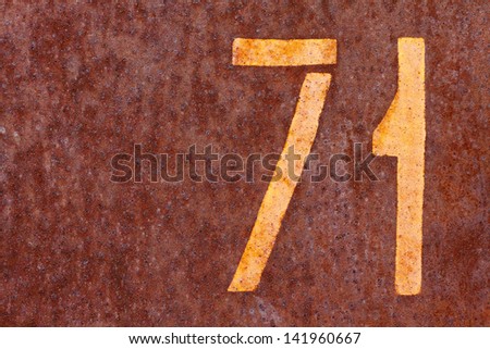 number seventy one on a rusty background