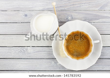 coffee and cream jug on a wooden table