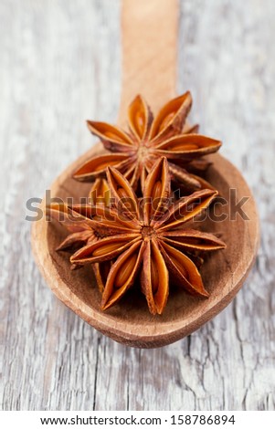 anise stars in a wooden spoon