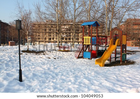 A big colorful children playground equipment  in snowy landscape