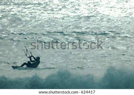 A parasurfer riding the waves