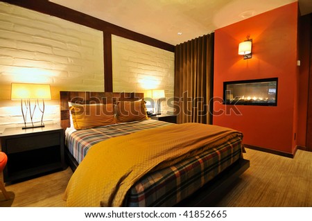 spacious boutique hotel room with fireplace and bed