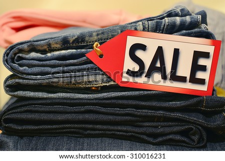 Seasonal sale. Pile of clothes with \