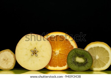 slices of fruit on a black background