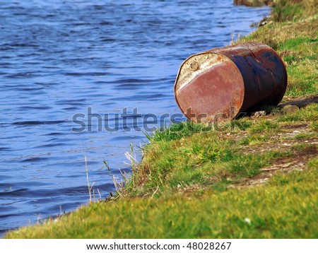 old oil drum abandoned on the river bank