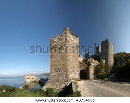 Golubac Fortress  panorama.  12th century castle located at the entrance of river Danube IRON GATE gorge. Main tower gate with fortified river dock on the left and rest of the towers on the right