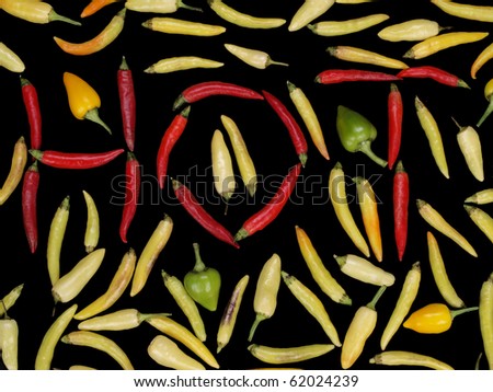 bunch of Hot peppers on black background red ones are spelling word HOT