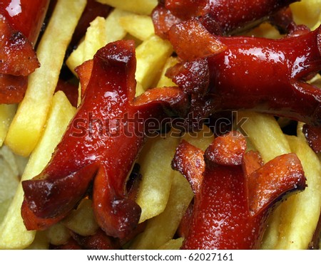 portion of French fries and fried sausages