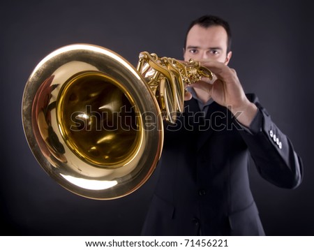 male musician playing strait soprano saxophone. focus on sax