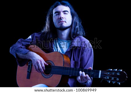 Man Playing Classical Guitar on Black Background