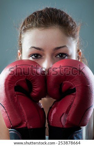 Boxing Woman Behind Two Worn Out Gloves