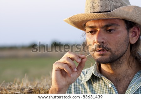 Farmer Thinking at Sunset with Straw in His Mouth