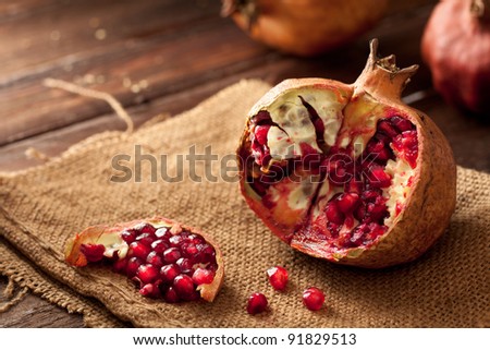 Pomegranate with Seeds on Jute and Wood