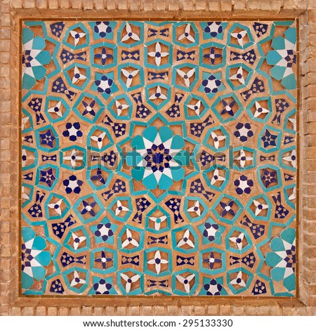 Flowers and stars motif design in Islamic Iranian pattern made of tiles and bricks in old Jame mosque of Yazd, Iran.