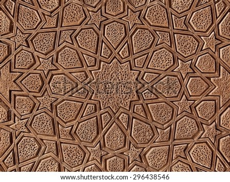 Islamic flowers and stars motif pattern, carved on the surface of an old wooden door.