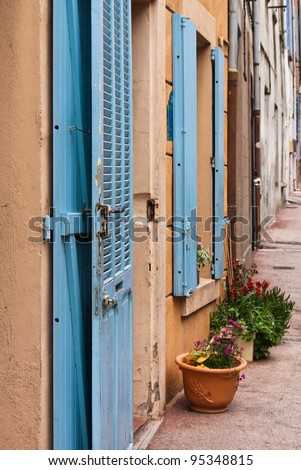 Houses with blue shutters in a row  in a small village in Provence in France.