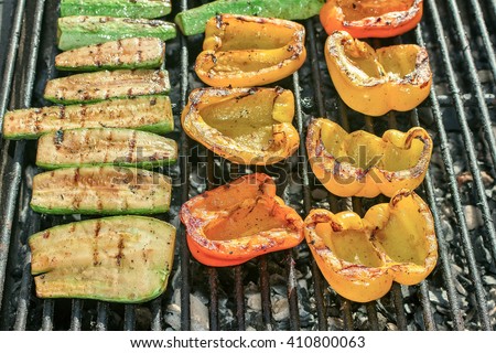Charcoal Grill with vegetables. Peppers, zucchini and cucumber.