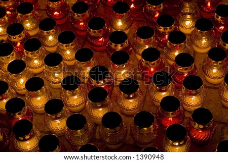 Many glass icon-lamps with lights from candles. Memorial Day in Ukraine.