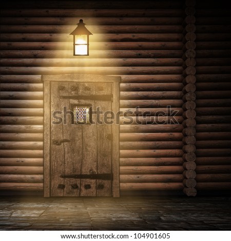 Wooden wall with door and light at night