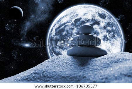 Macro of three staked zen stones in space against planet