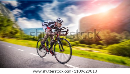 Cyclist rides on bicycle, speed effect, side view