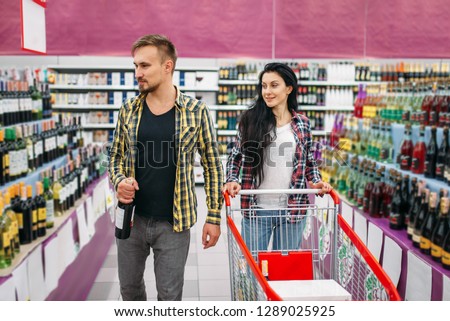 Young couple in supermarket, holiday shopping