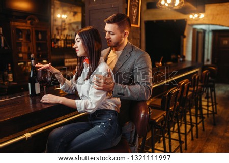 Man and woman relax, couple at wooden bar counter