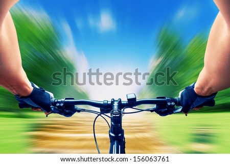 Man riding on a bicycle very fast, motion blur