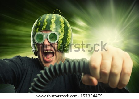 Bizarre man in a helmet from a watermelon riding fast