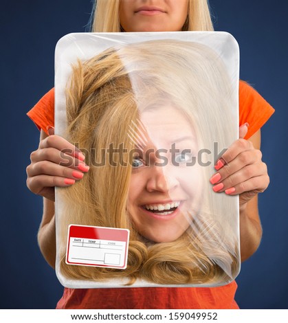 Surprised female head wrapped in food tray