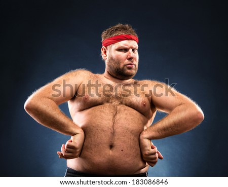 Fat man imitating muscular build