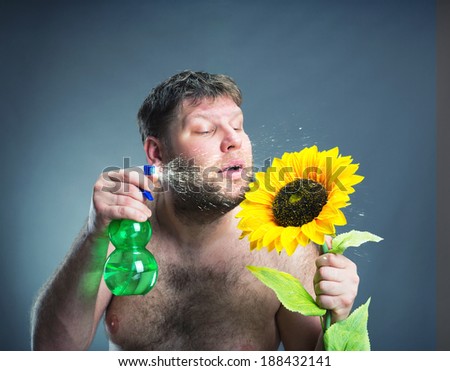Portrait of man with sunflower, studio shoot
