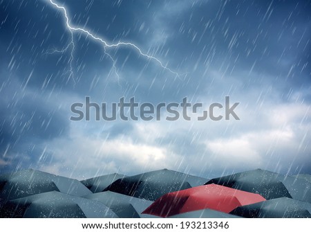 Umbrellas under rain and thunderstorm