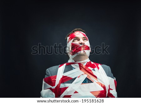 Man with stripped duct tape over body