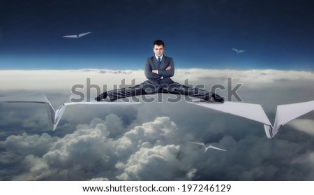 Businessman flying on paper planes