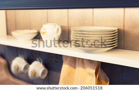 White plates and dinnerware in a cupboard