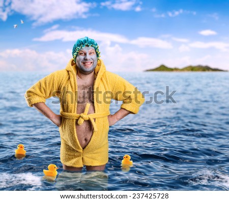 Strange man with face pack stands in water