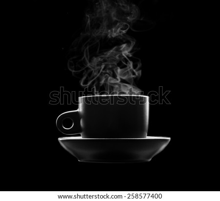 Cup of hot beverage on black