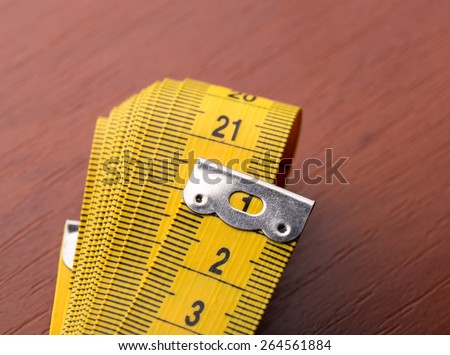 Macro of measurement tape on the wooden table