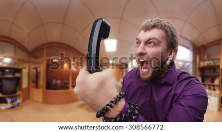 Angry man speaks on the phone